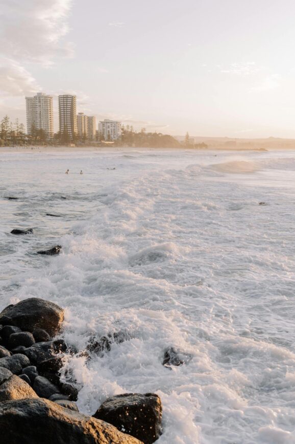 ocean view with rocks and city