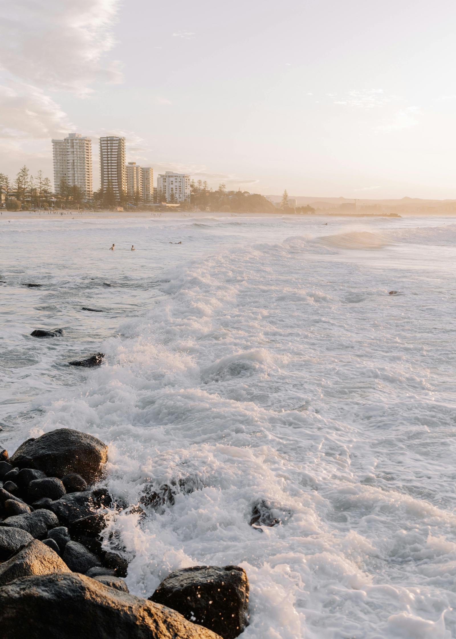 ocean view with rocks and city